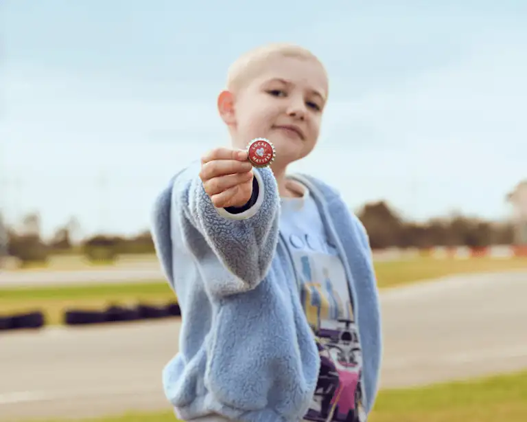 My room child holding a Local Matters token