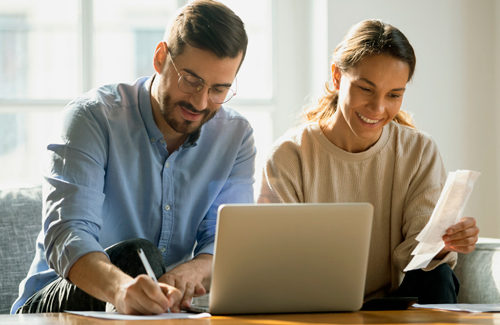 Man and woman in front of laptop.
