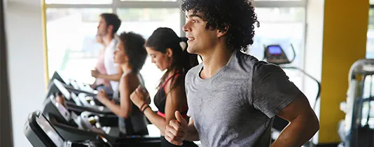 ISSA Running Coaches jogging on a treadmill