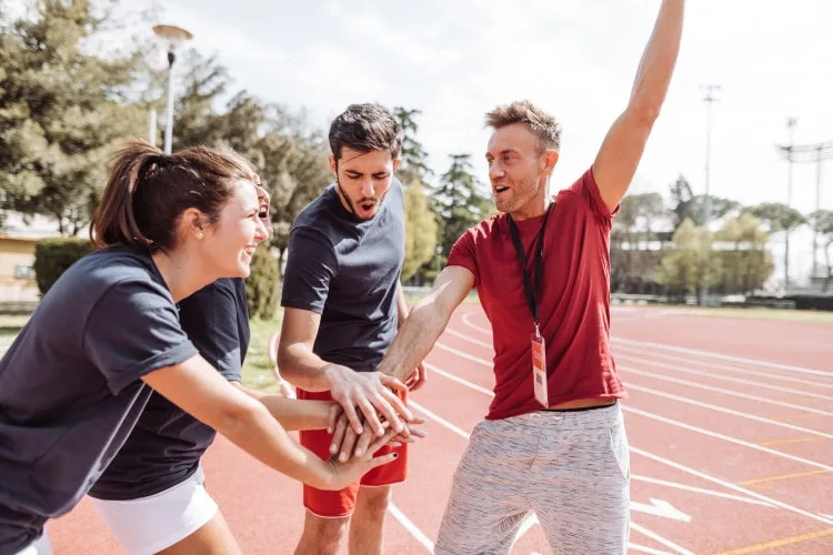 ISSA trainer and clients working out outside on track