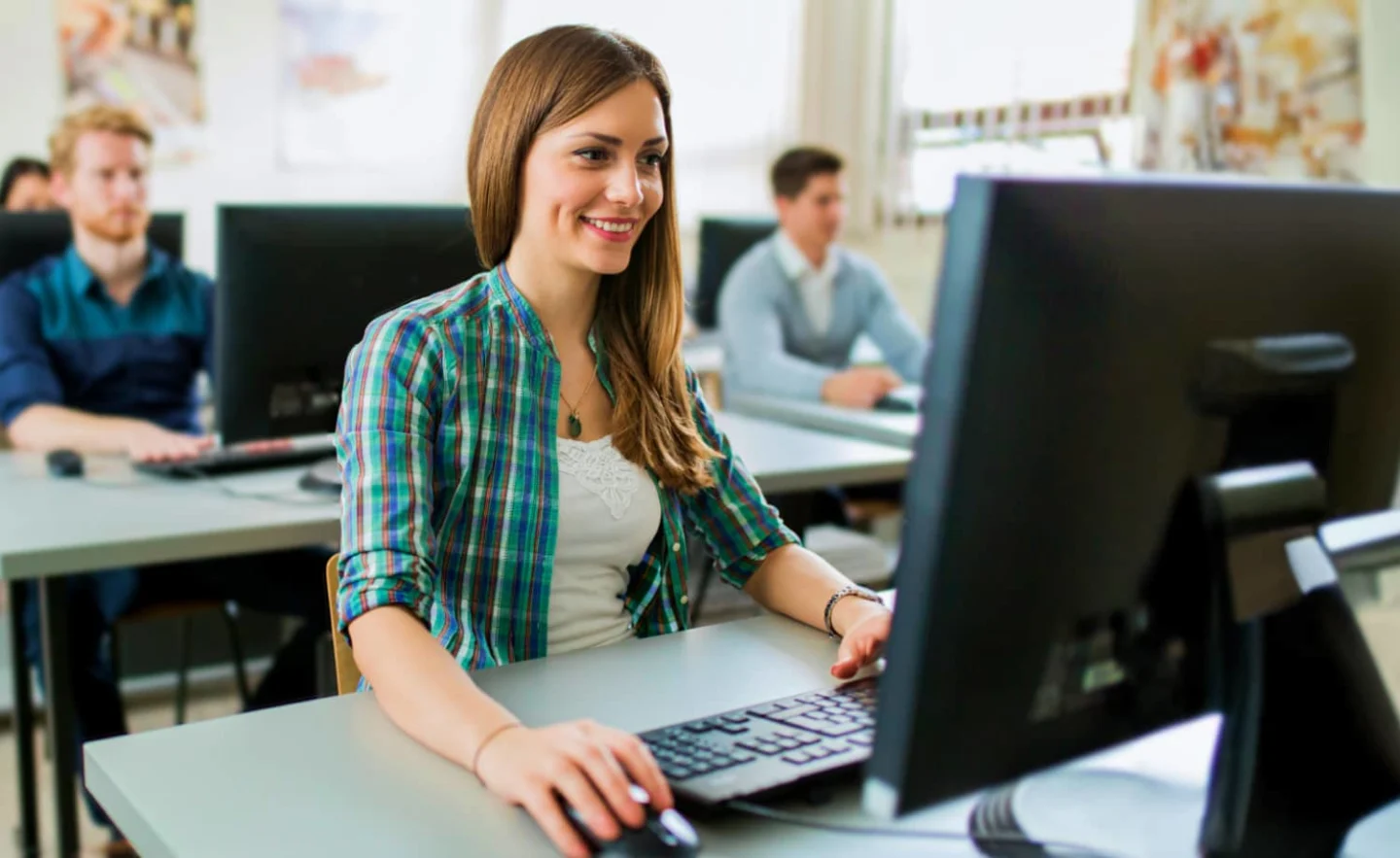 ISSA student reviewing NCCPT exam on computer.