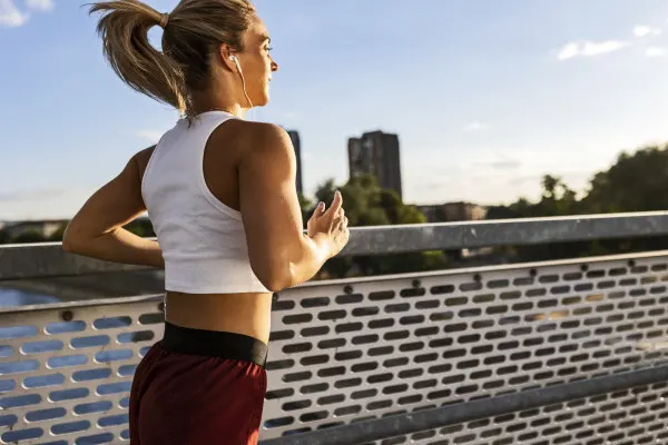 Woman running across bridge