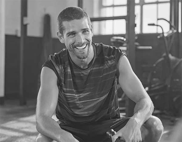 Certified Personal Trainer smiling in a gym