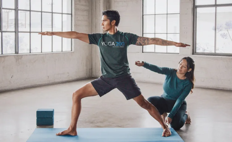 ISSA trainer and client doing yoga on yoga mat