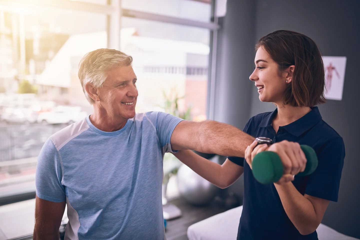 Trainer and older client working on fitness for stroke recovery