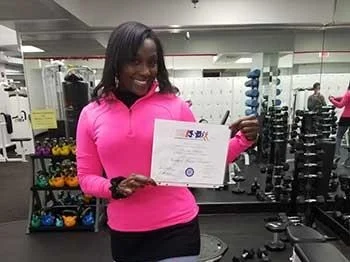 An ISSA Trainer showing off her certificate