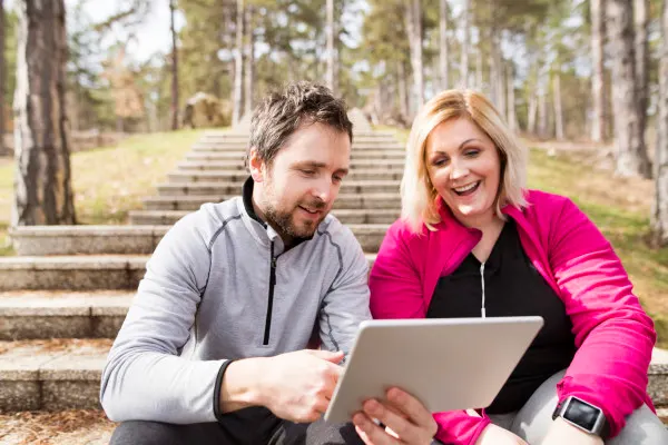 Fitness trainer talking to overweight woman.