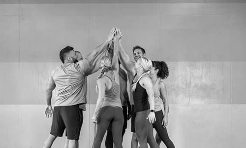 Group of Certified Personal Trainers high-fiving