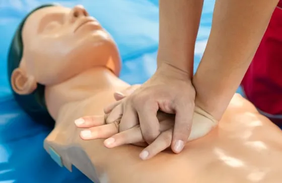 Trainer practicing CPR in class.