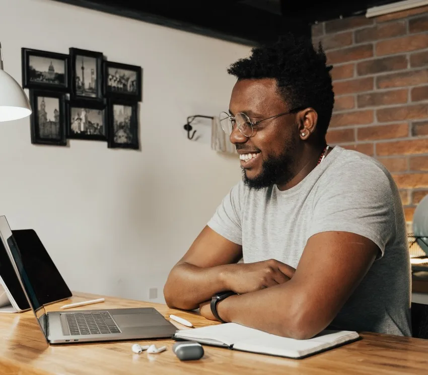 Man smiling looking at laptop