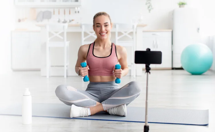 Online Coach filming a class with her phone