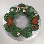 Deze leuke opgespoten cupcakes worden geleverd in de vorm van een krans. Kerst krans cupcakes
