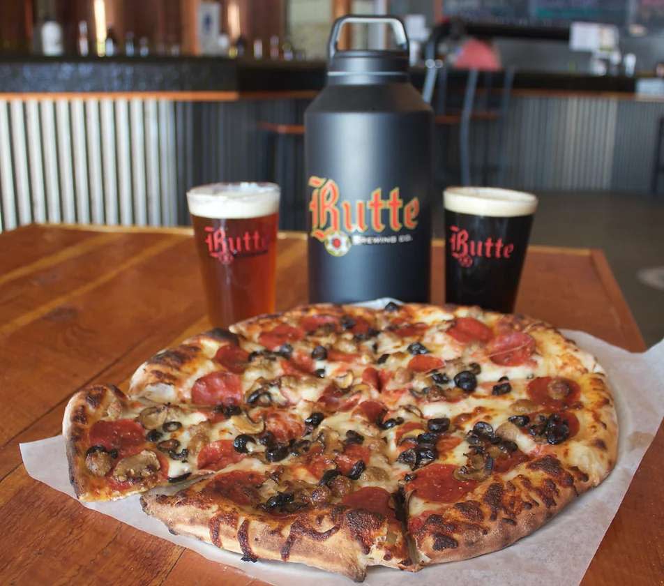 A picture of a pizza and beer at Butte Brewing and Pizza Company