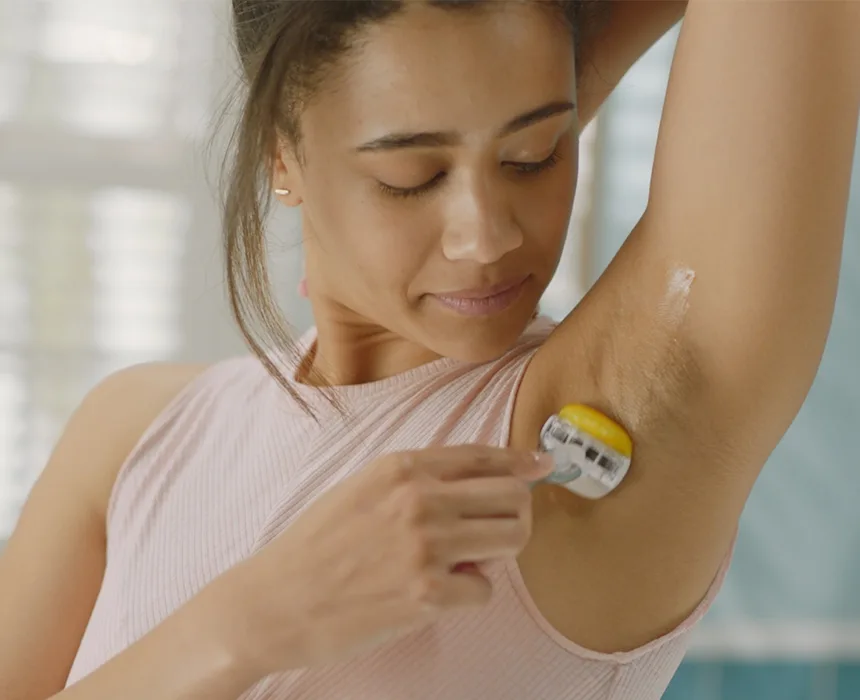 Woman shaving her armpit.