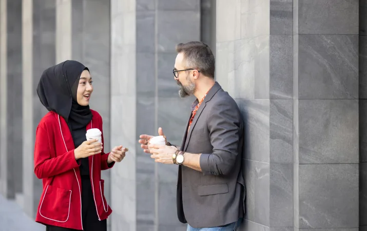 A provisional psychologist chatting to her supervisor during a break