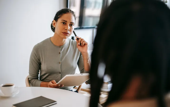 A psychologist listening intently to a client during a session