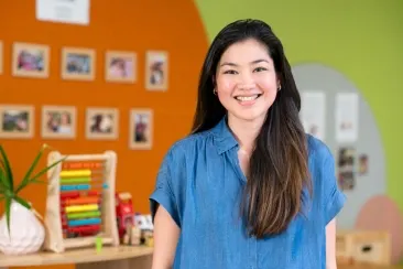 Open Universities Australia student, Nikki, standing in a classroom.