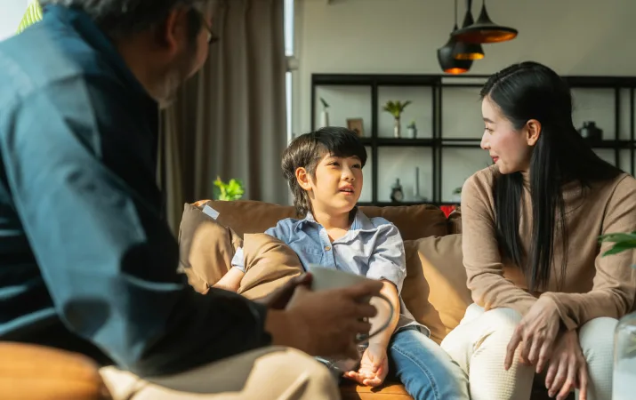 A psychologist working with a mother and her child during a therapy session