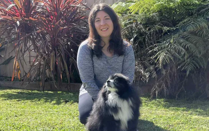 Dr Jennifer Cutri from Swinburne University playing with her dog in her backyard