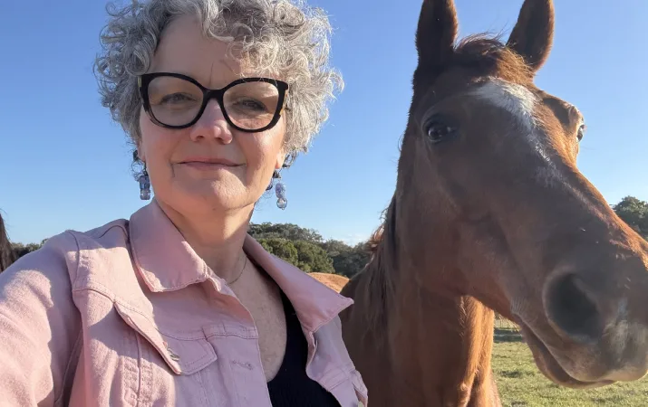 Associate Professor Jacqui Yoxall with her horse in the countryside