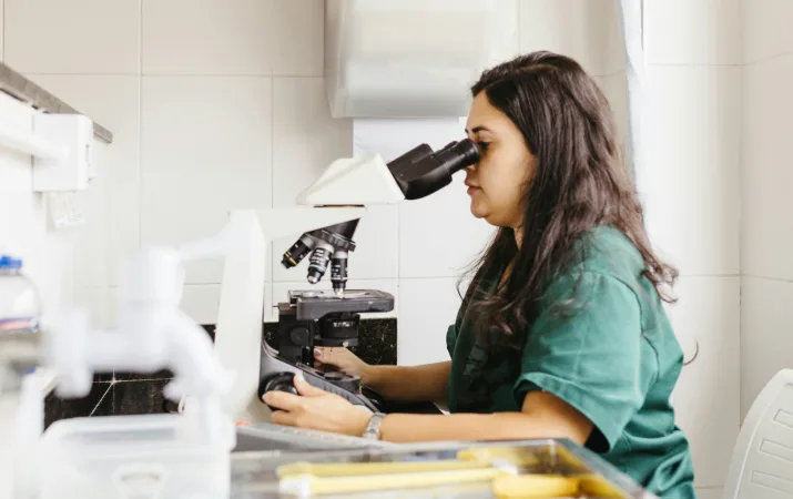 Student looking into a microscope during lab work