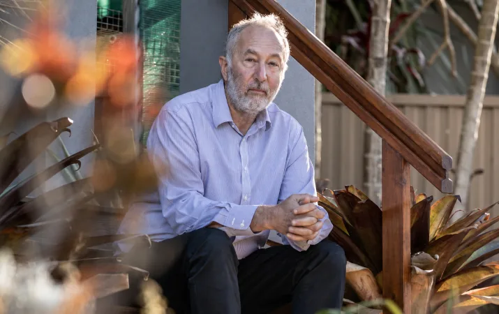 An older man staring thoughtfully at the camera