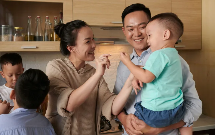 Happy family of five in their kitchen