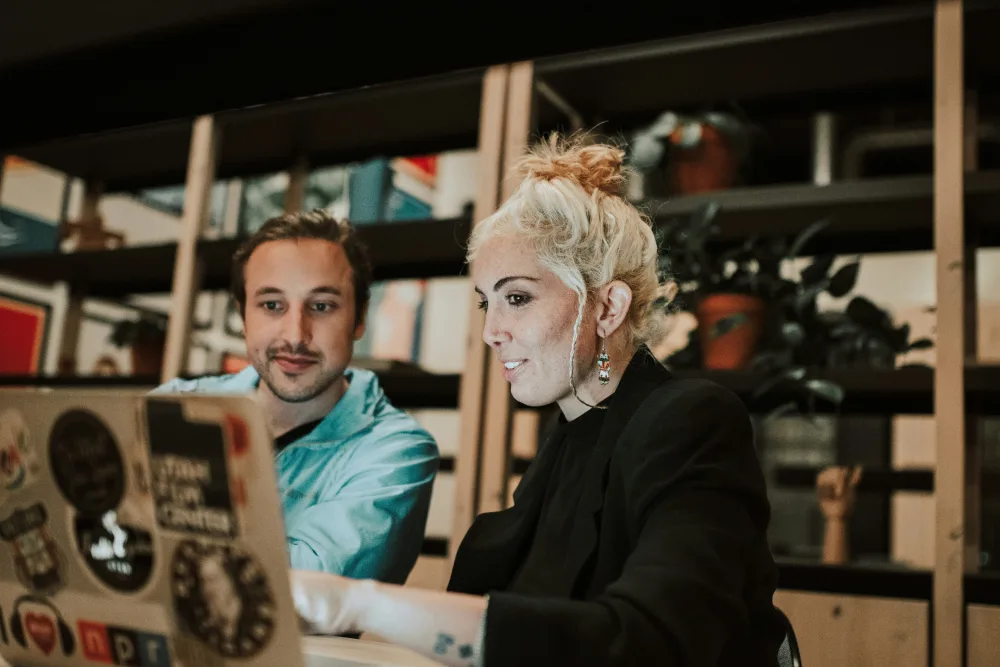 Two graphic designers collaborating in an office.