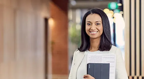 Open Universities Australia student Kelly wearing professional clothes in a business setting.
