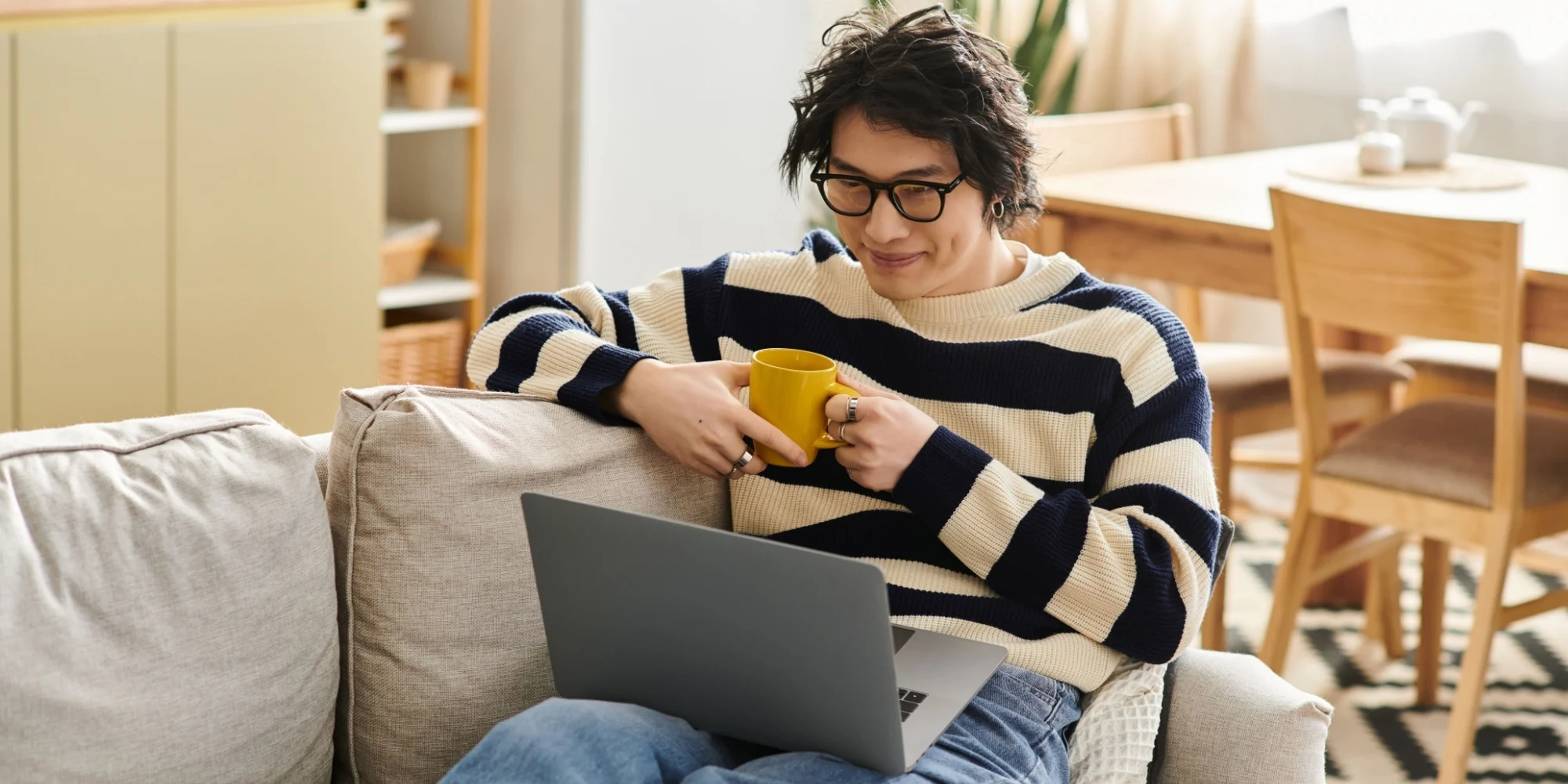 A student enjoying relaxed study time with a coffee, preparing for the IELTS test.
