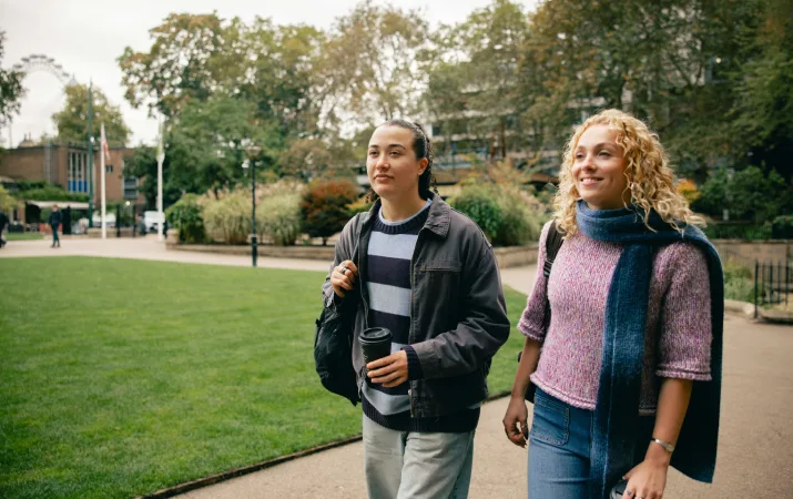 Two women walking through a uni campus