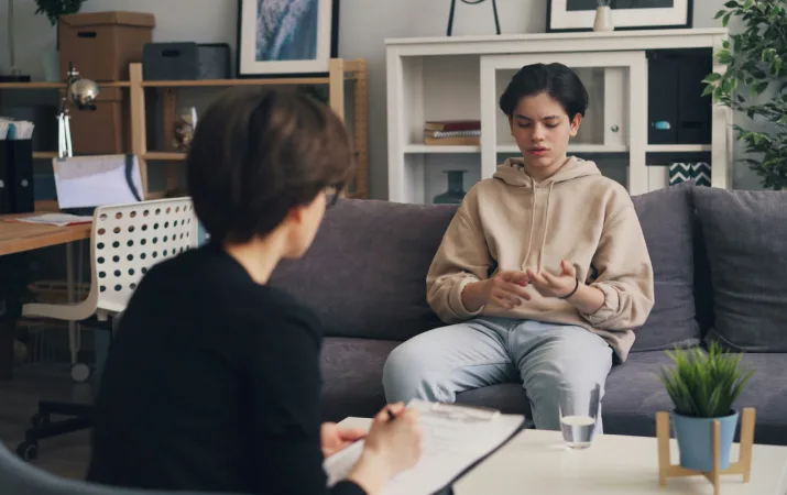 A counsellor in a therapy session with a young adult in her home office