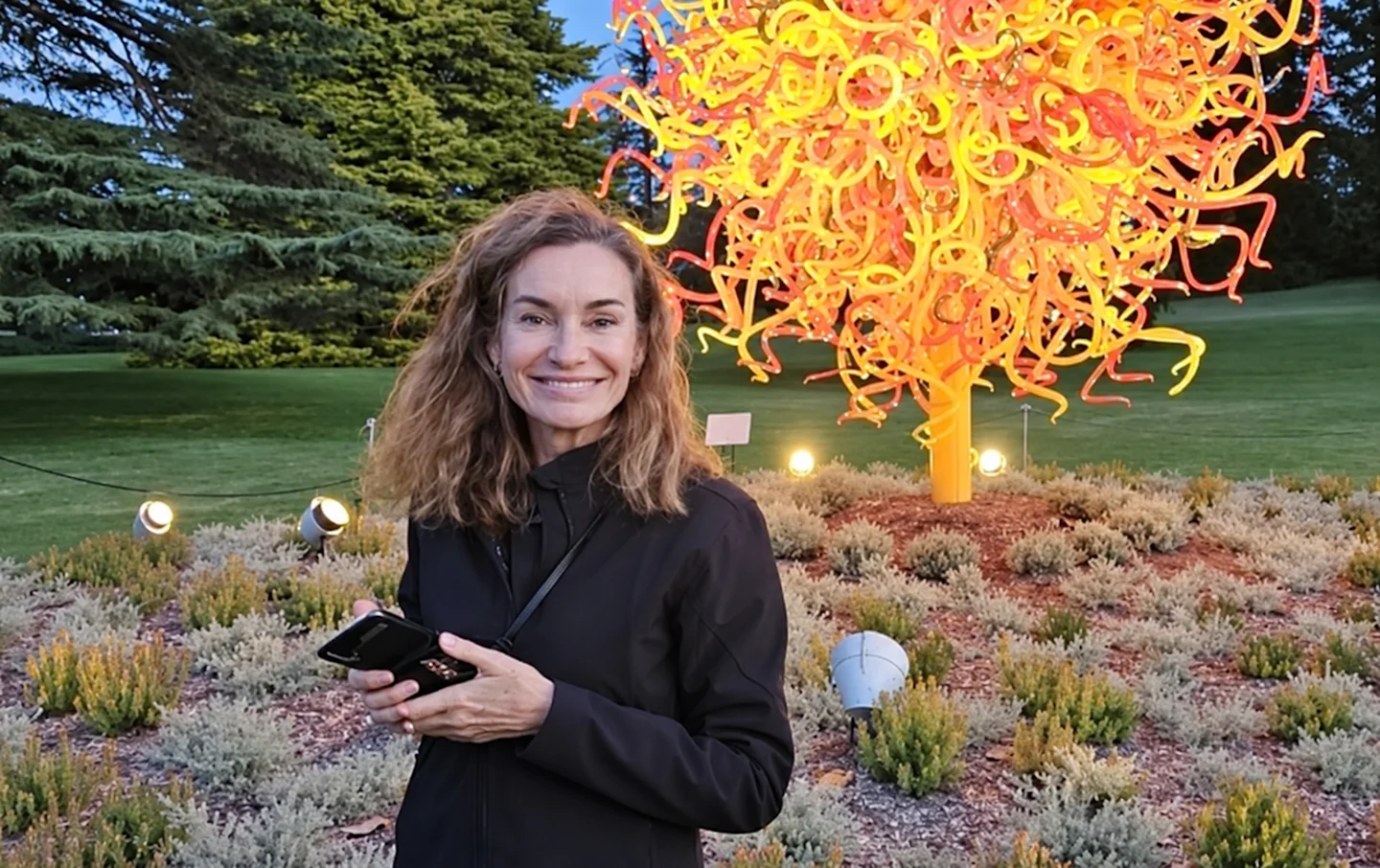 Friendly woman standing in front of art installation