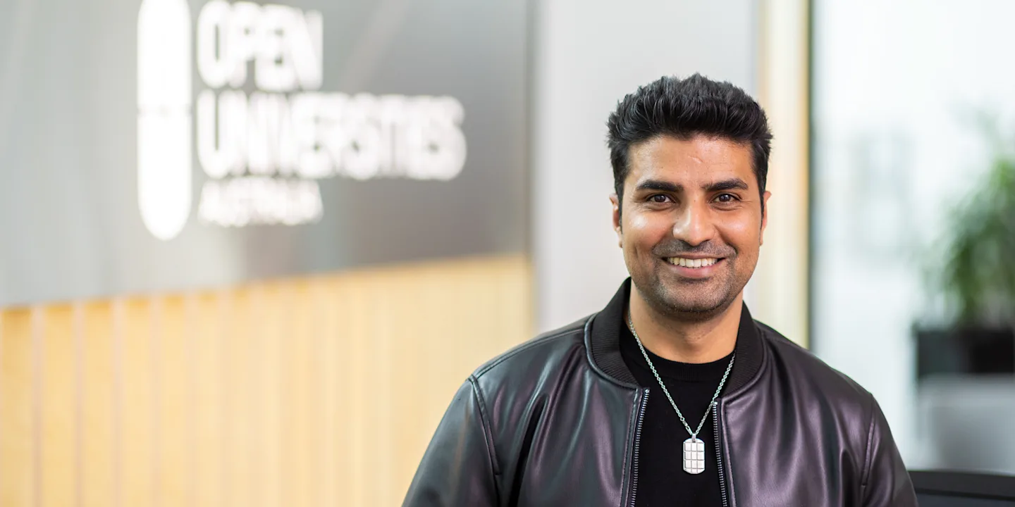 OUA student advisor Naeem standing in OUA's bright reception.