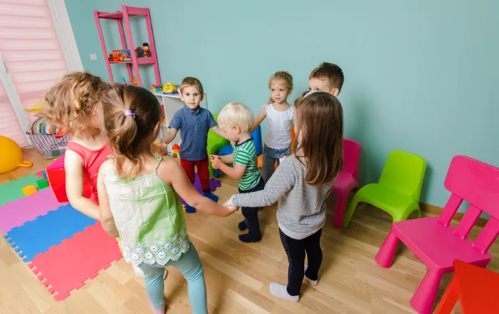 Kindergarten children playing in a circle