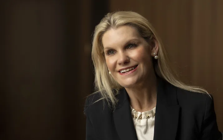 Catherine Hufton, a smiling blonde woman in corporate attire