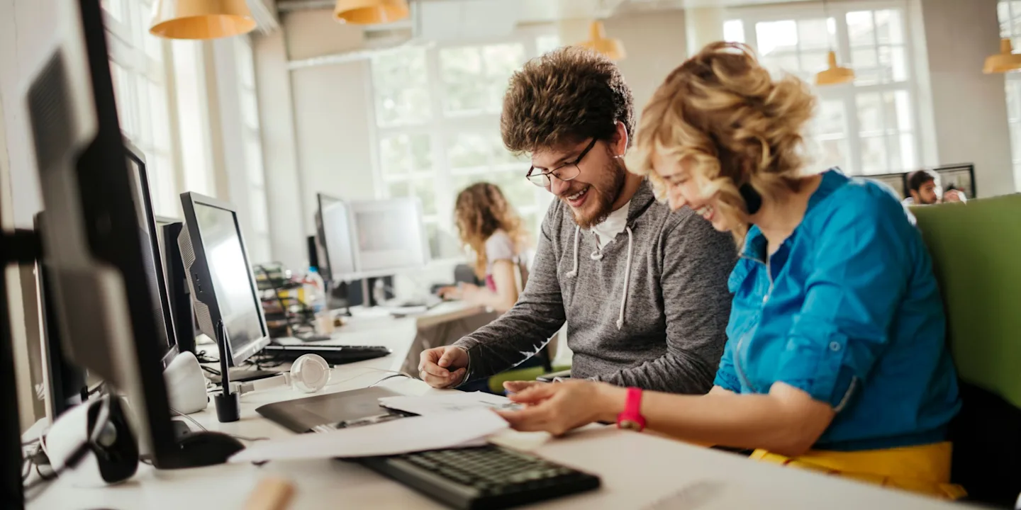 IT professionals enjoying collaboration in a bright and modern workplace.