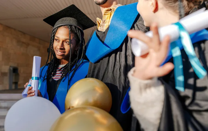 A Year 12 graduate staring into the distance and dreaming about her future teaching career at her high school graduation