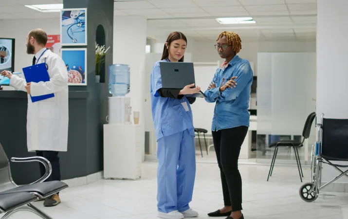 A psychologist consulting with a doctor on a patient's wellbeing in a hospital