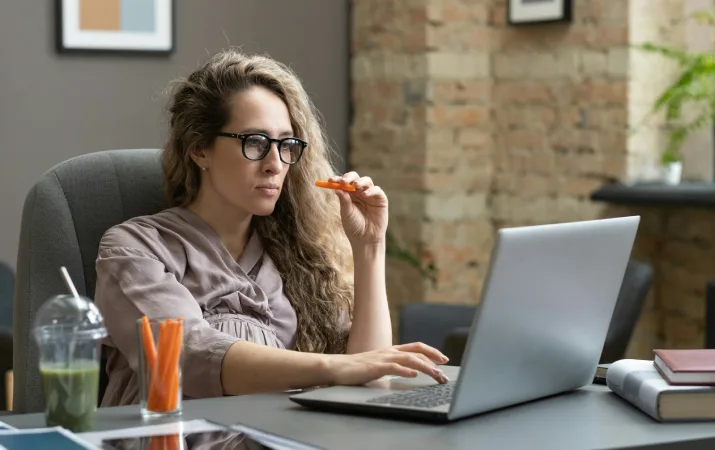 A teacher upskilling on a laptop during her lunch break