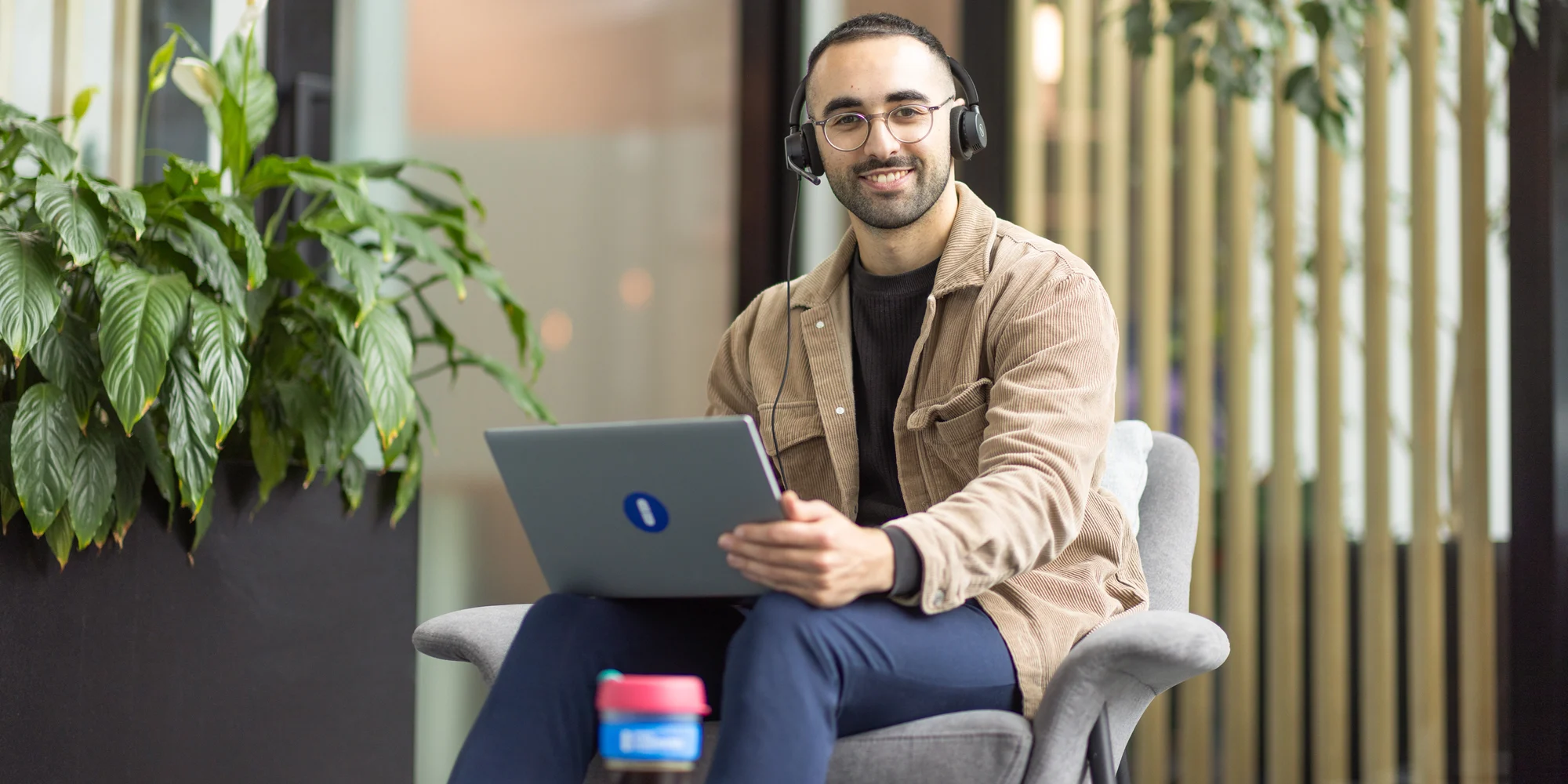 Open Universities Australia student advisor working on a laptop in a modern office.
