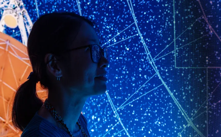 Dr O. Ivy Wong, a CSIRO Science Leader, infront a star map