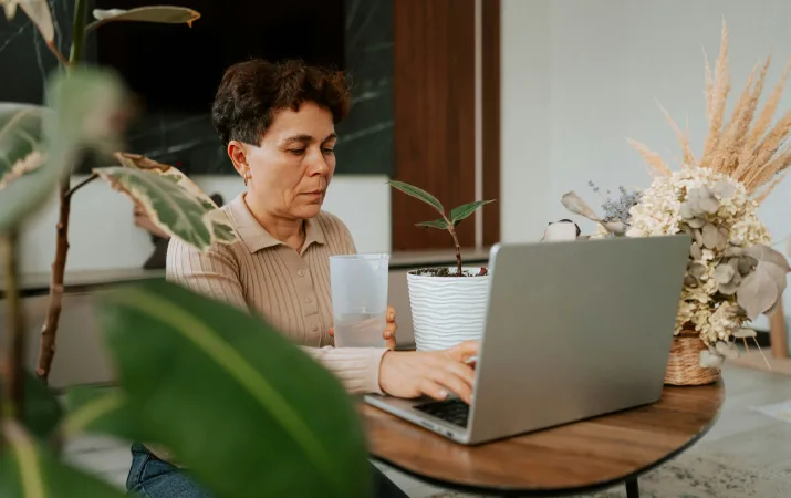 A mature-aged student on her laptop considering using her work and life experience to get into a psychology qualification