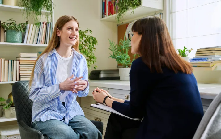 A client speaks enthusiastically to her psychologist 