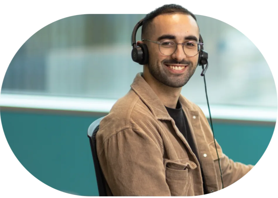 Open Universities Australia student advisor, Josh, seated at a workstation.