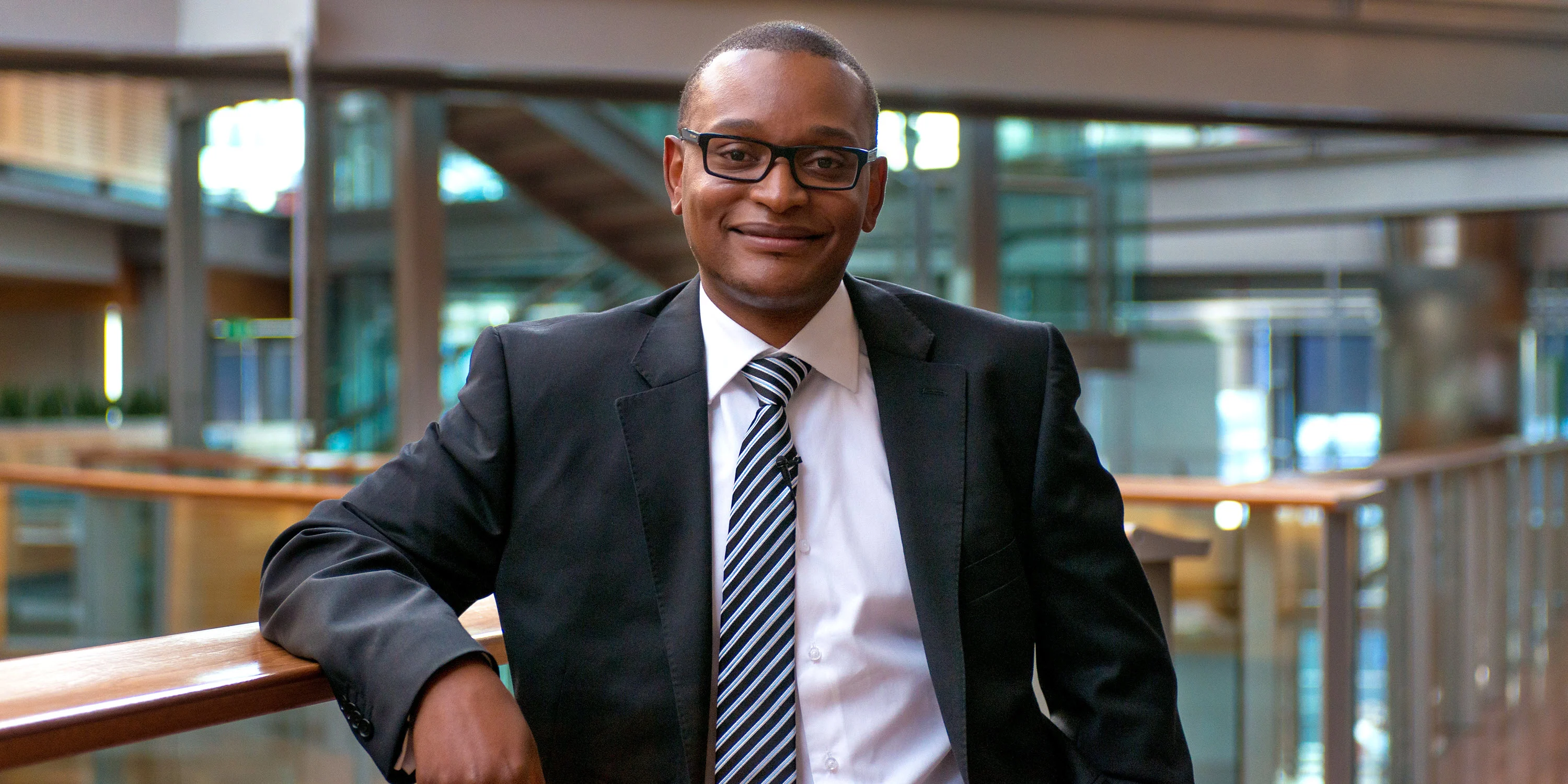 Postgraduate student Edward at work in a modern office building