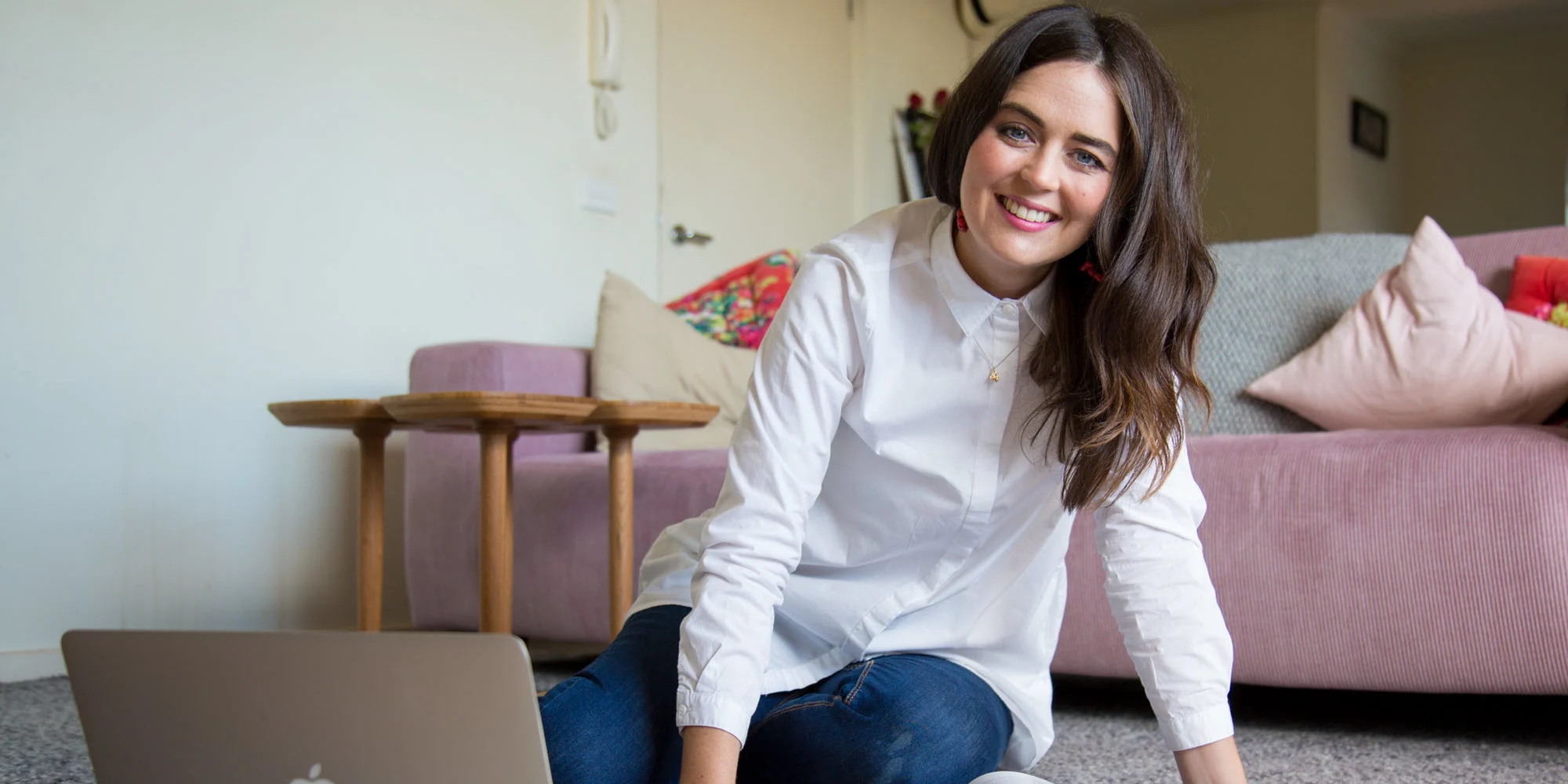 Business student happily studying in the lounge room.