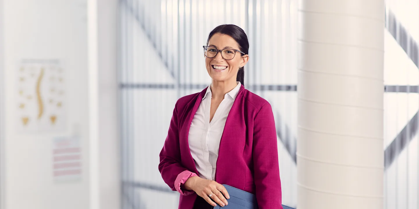 Health student smiling in a bright professional workspace.