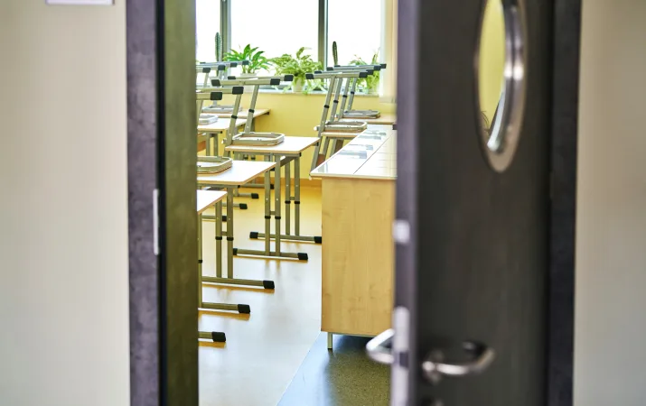 An empty classroom with the door open