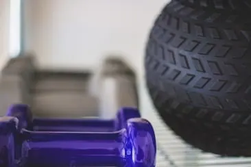 Exercise equipment including hand weights, dumbbells, and a textured massage ball 